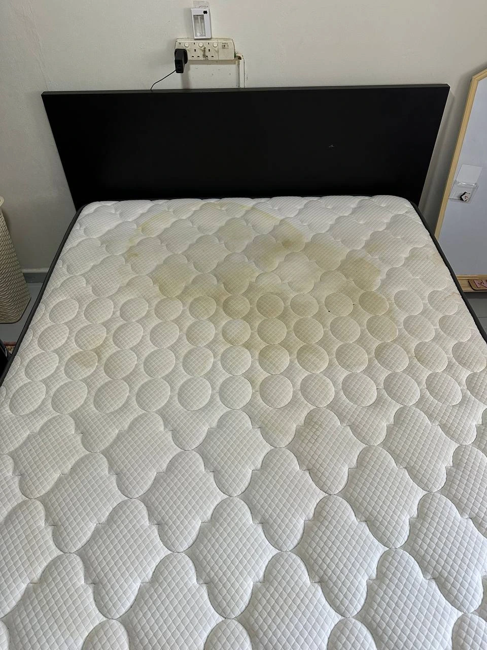 Dirty mattress before professional cleaning showing stains and wear